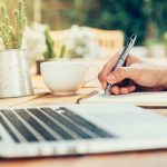 Image of someone writing something down