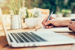 Image of someone writing something down